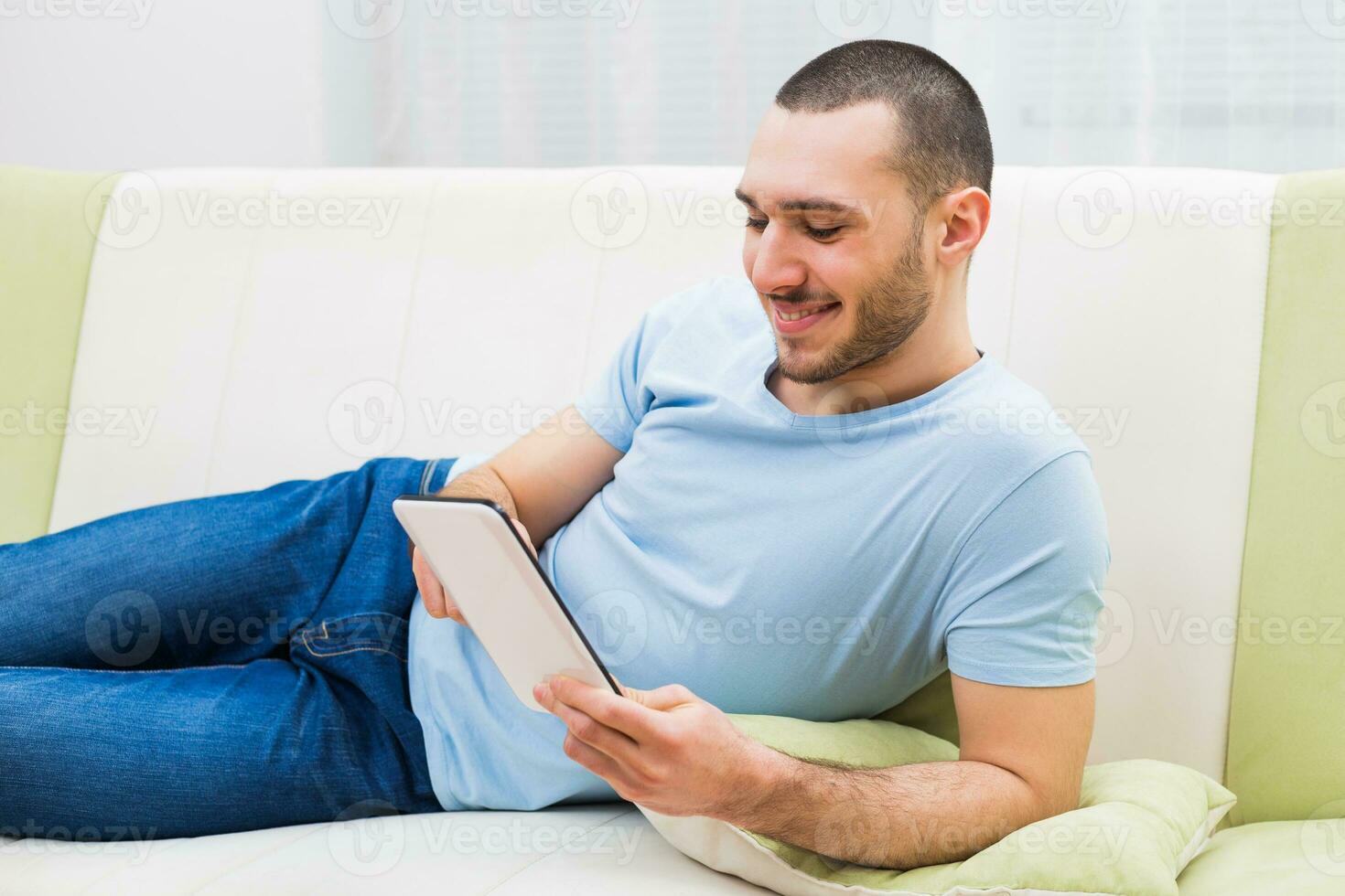 Young man using digital tablet at his home photo