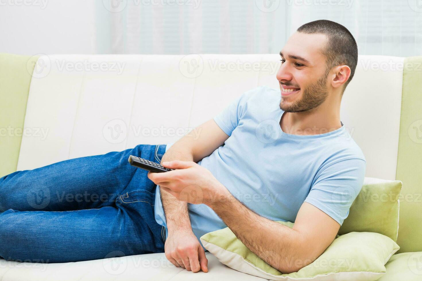Young man enjoys watching tv photo