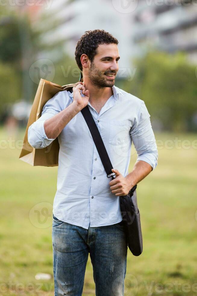 Young businessman took a break from work to go for a shopping photo