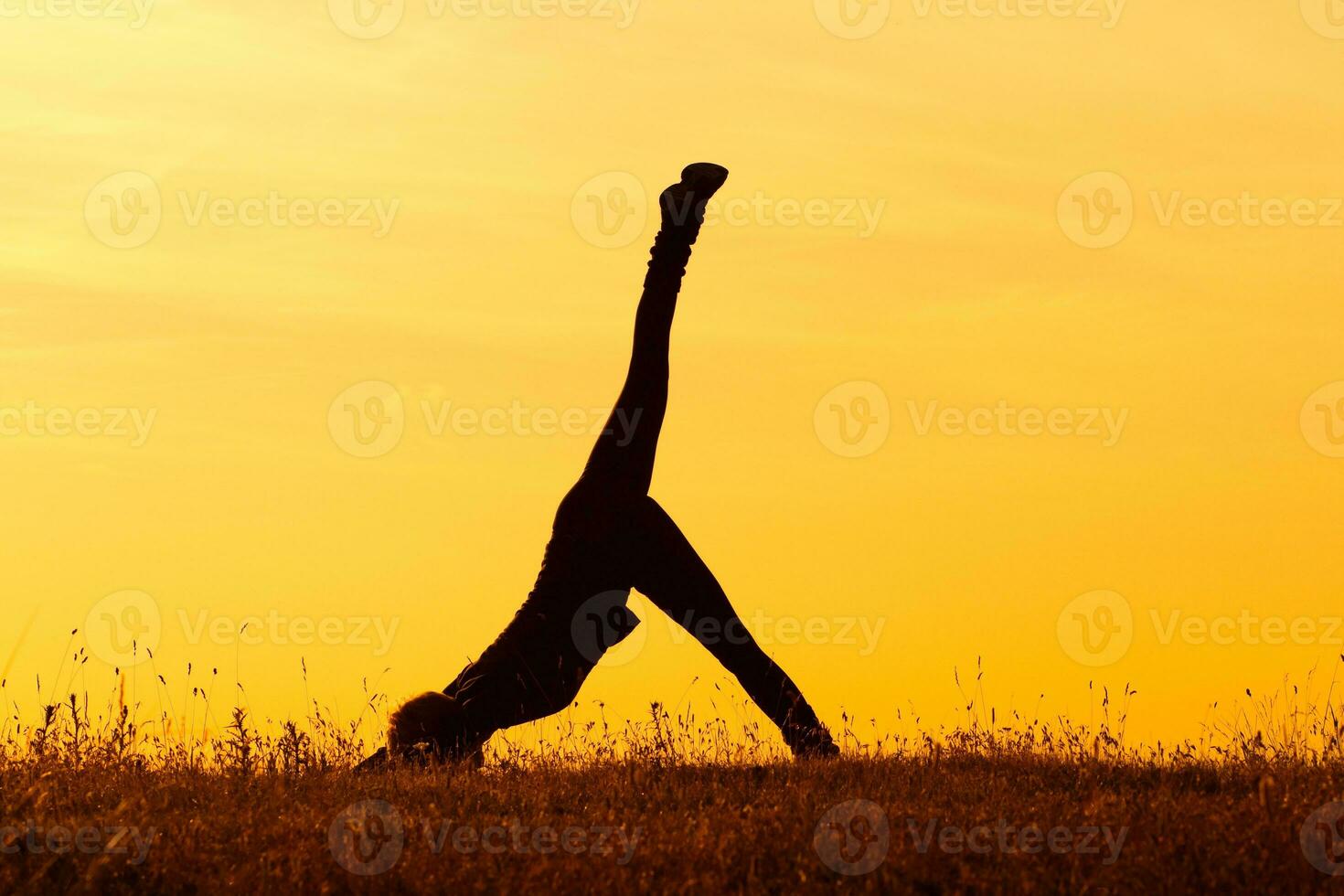 Silhouette of woman doing yoga photo