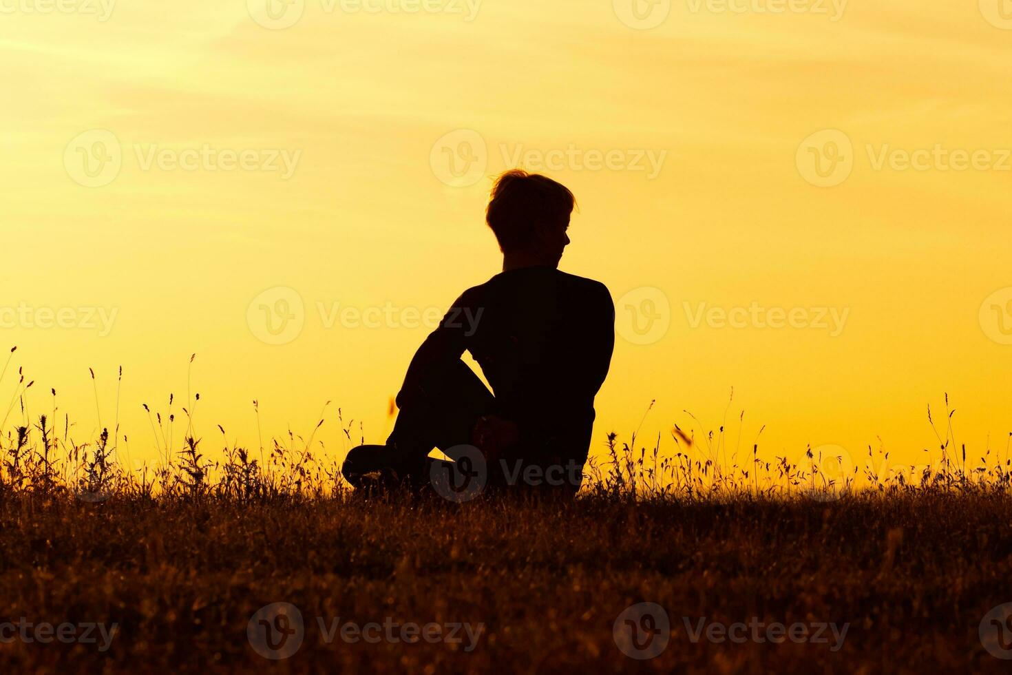 Silhouette of woman doing yoga photo