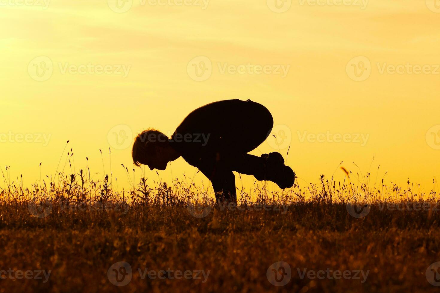 Silhouette of woman doing yoga photo