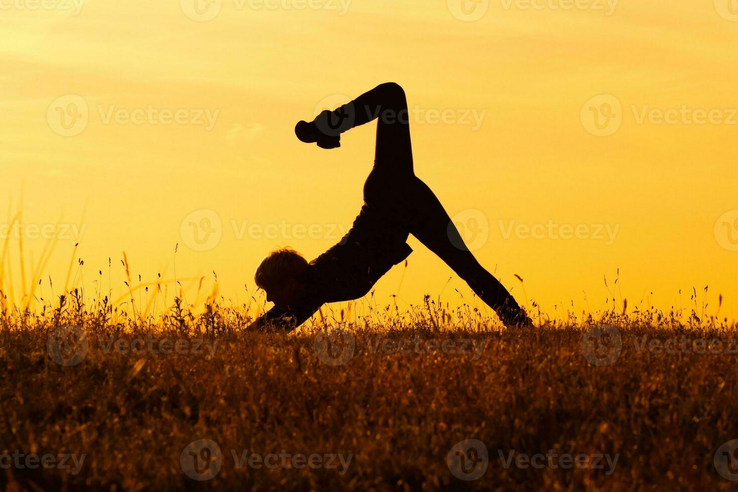 Silhouette of woman doing yoga photo