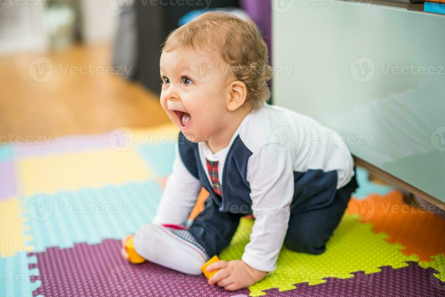 Image of cute baby boy crawling on the floor photo