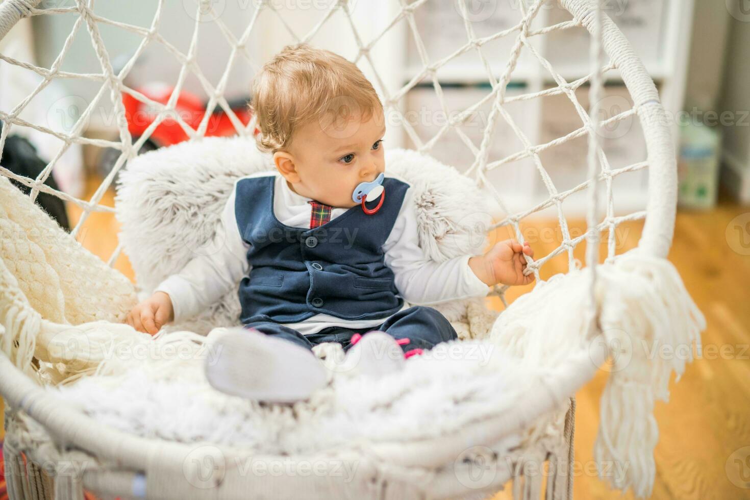 Image of cute baby boy with pacifier sitting photo