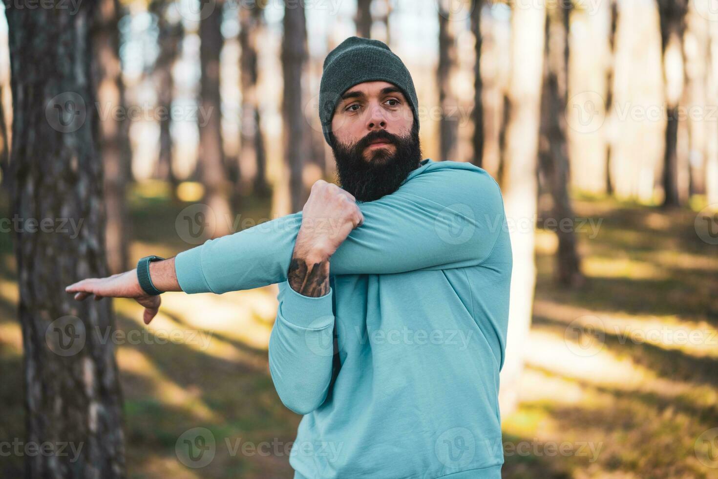 Man with beard enjoys exercising in nature photo