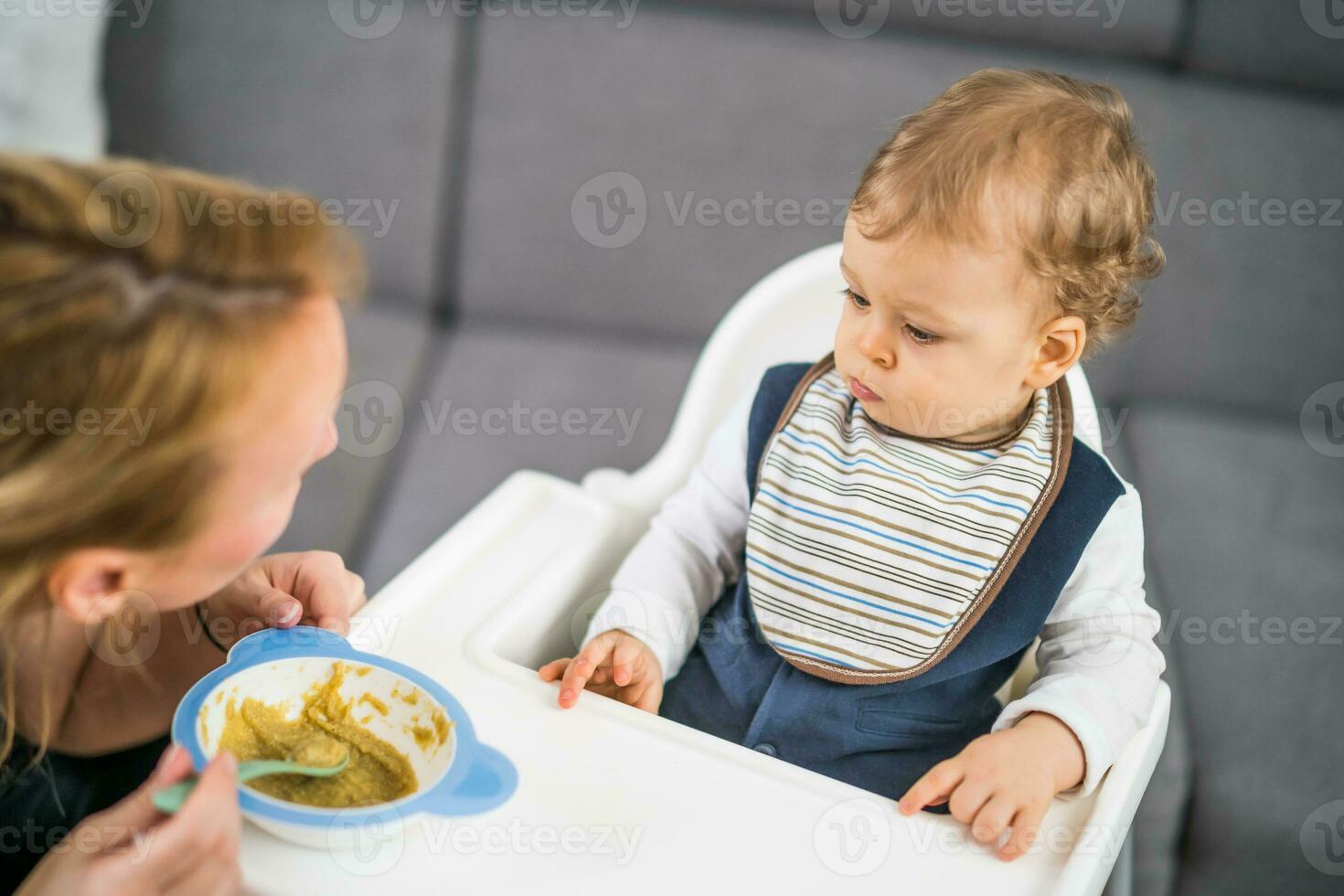 Angry baby boy doesn't want to eat photo