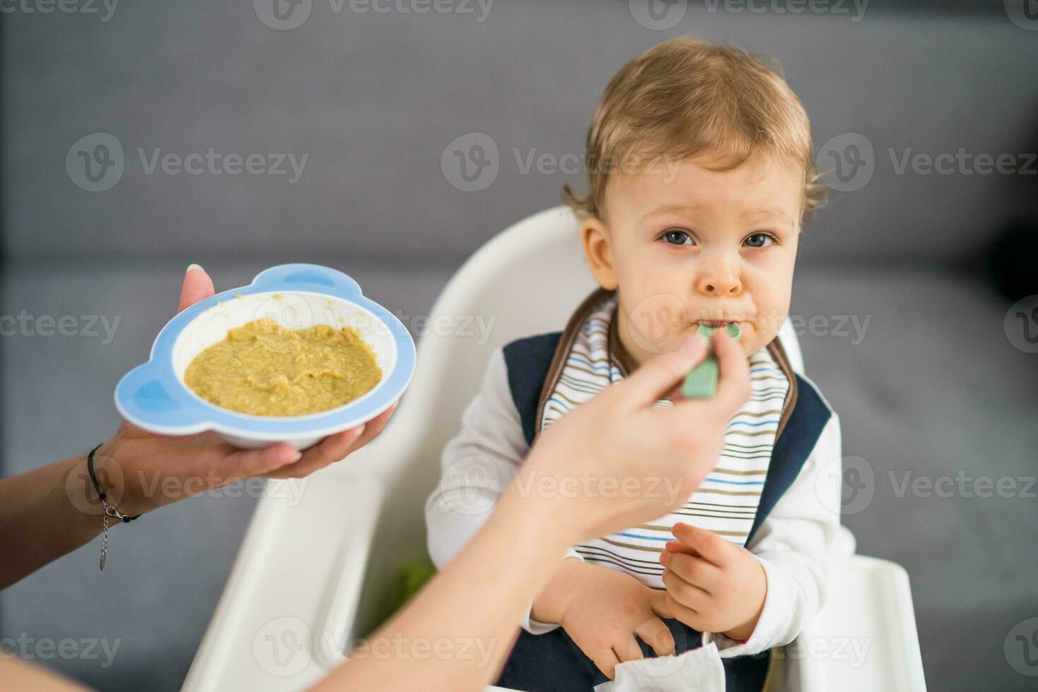 Angry baby boy doesn't want to eat photo