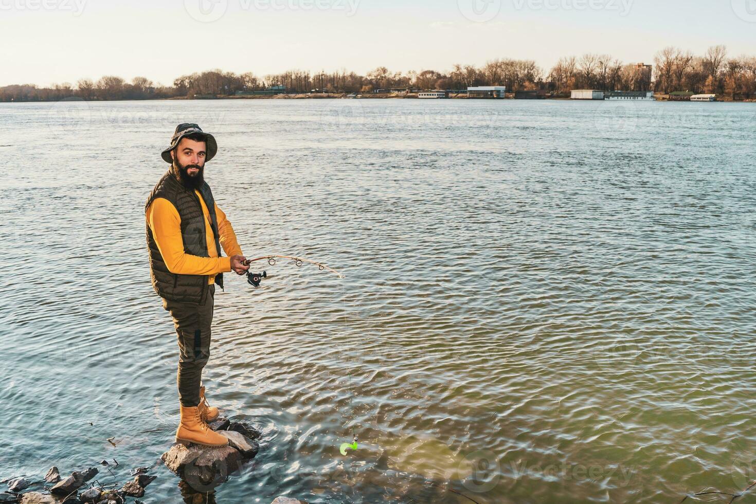 Man enjoys fishing at the river photo