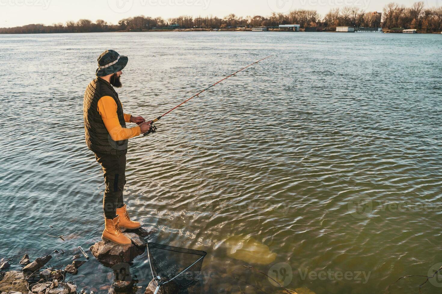 Man enjoys fishing at the river photo