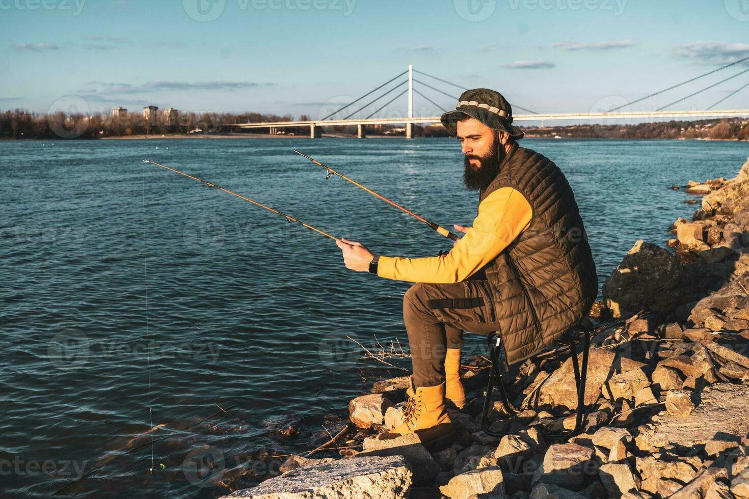 Man enjoys fishing by the river photo