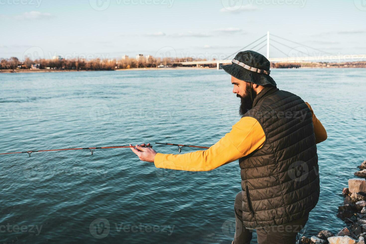 Man enjoys fishing at the river photo