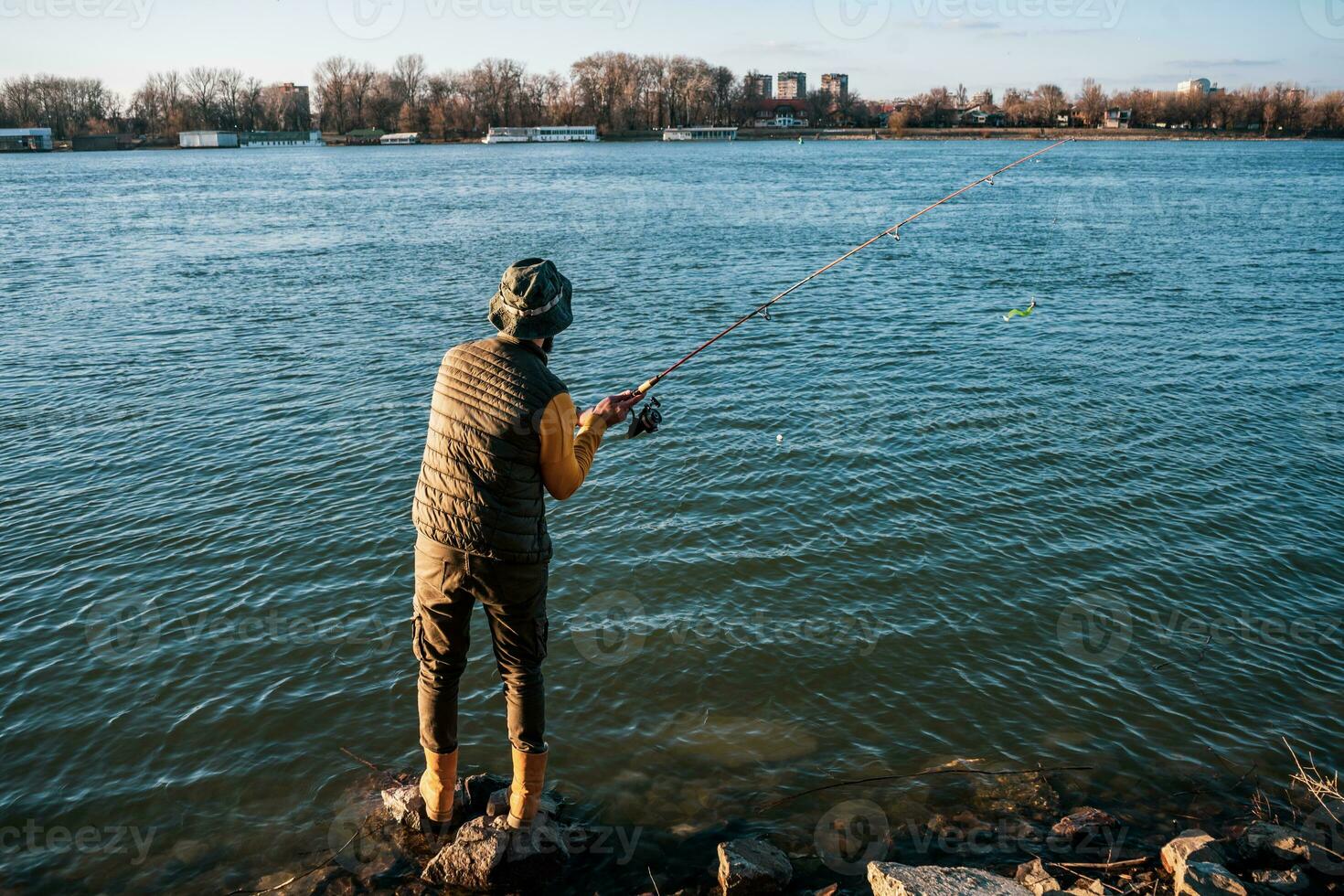 Man enjoys fishing at the river photo