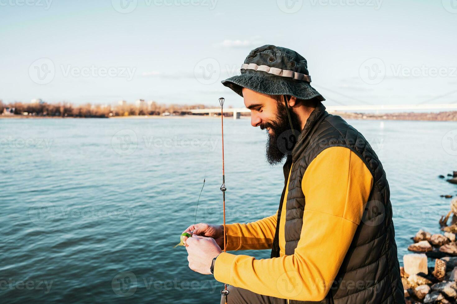 Man enjoys fishing at the river photo