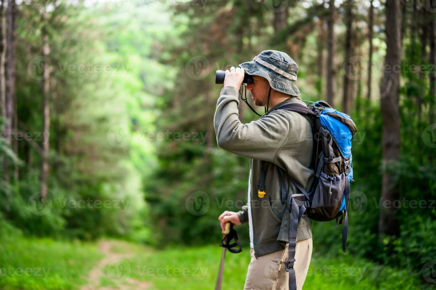 Image of man hiking and using binoculars photo