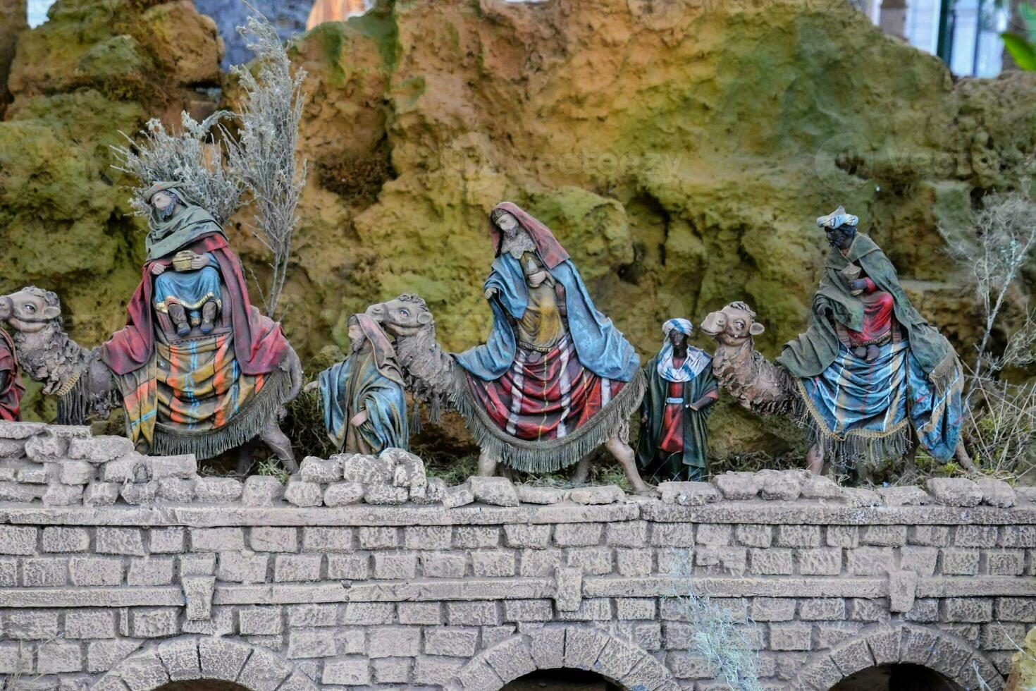 a nativity scene with figurines of people on camels photo