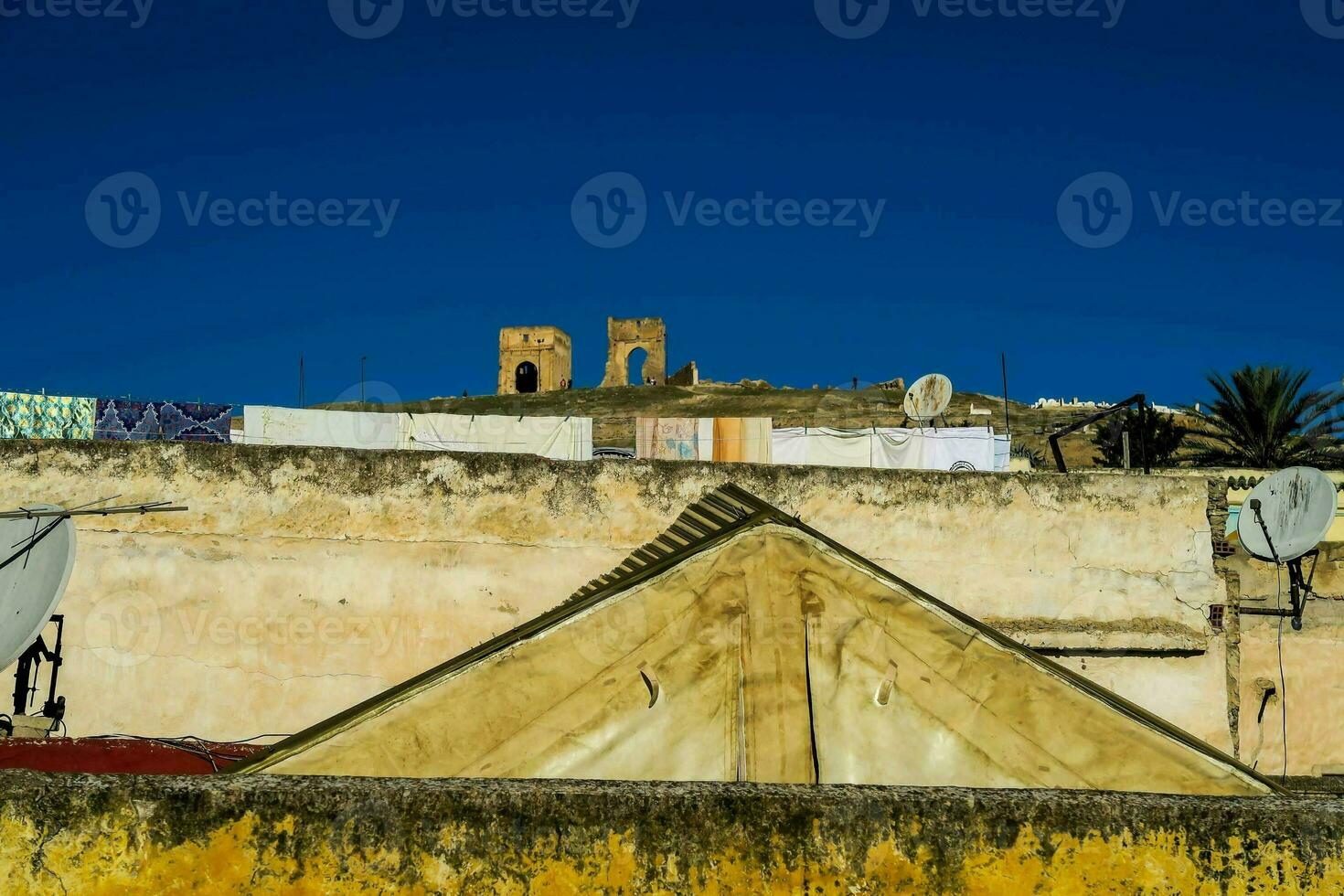 a view of the roof of an old building with a church on top photo