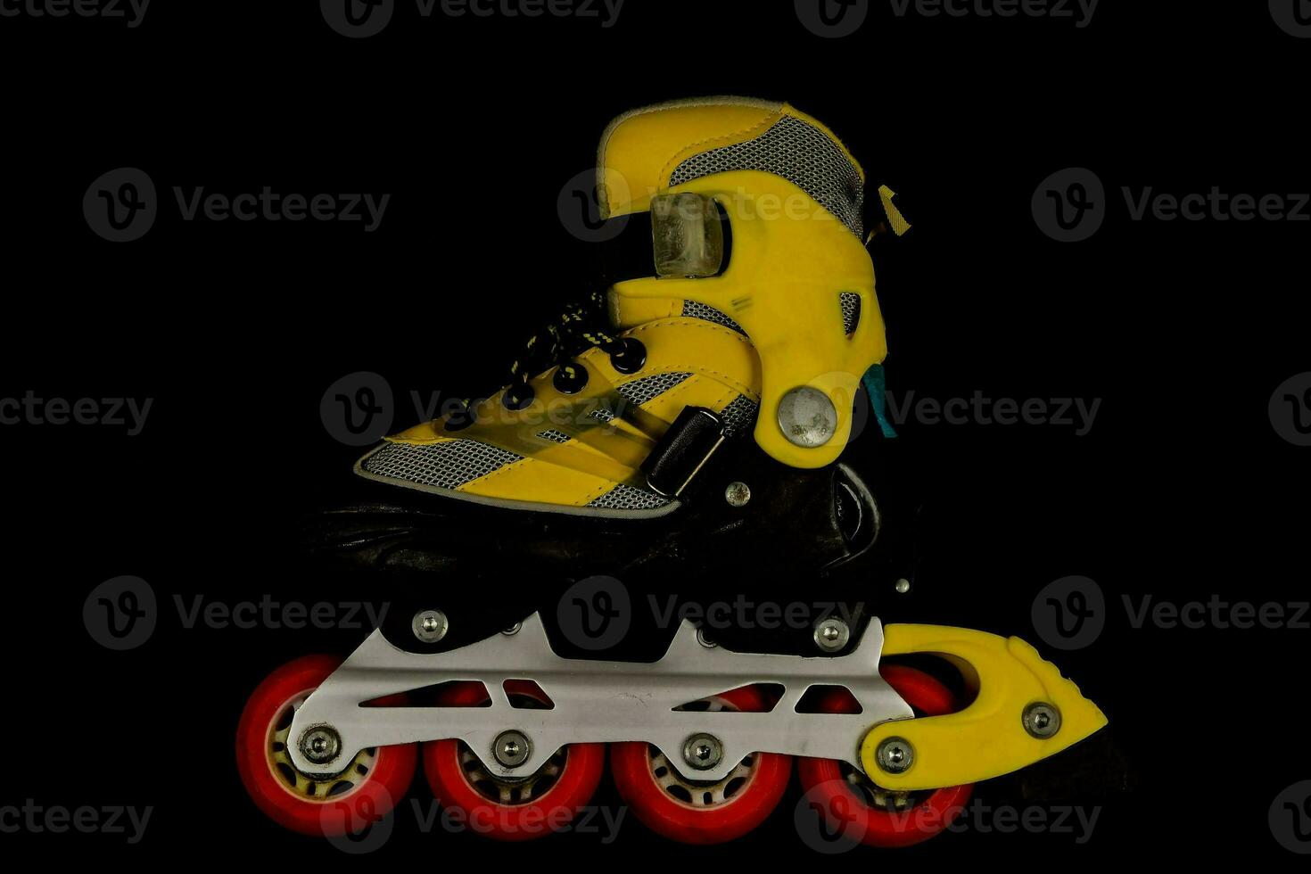 a yellow and black inline skate on a black background photo