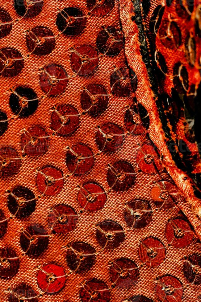 a close up of red sequined fabric photo