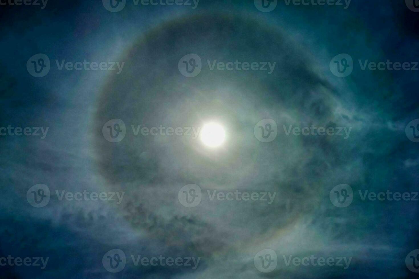the moon is seen in the sky with a halo around it photo