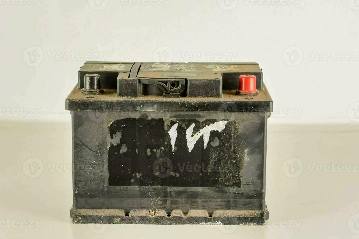 an old car battery with a white background photo