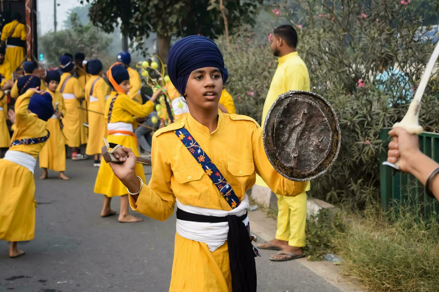 Delhi, India, October 2, 2023 - Sikhs display gatka and martial arts during annual Nagar Kirtan, Traditional, procession on account of birthday of Guru Nanak Dev ji, Nagar Kirtan in East Delhi area photo
