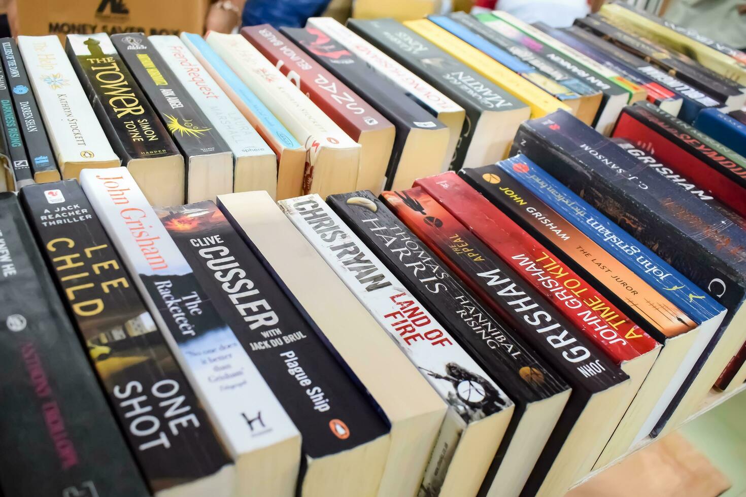 New Delhi, India, September 09 2023 - Variety of Books on shelf inside a book-stall at Delhi International Book Fair, Selection of books on display in Annual Book Fair. photo