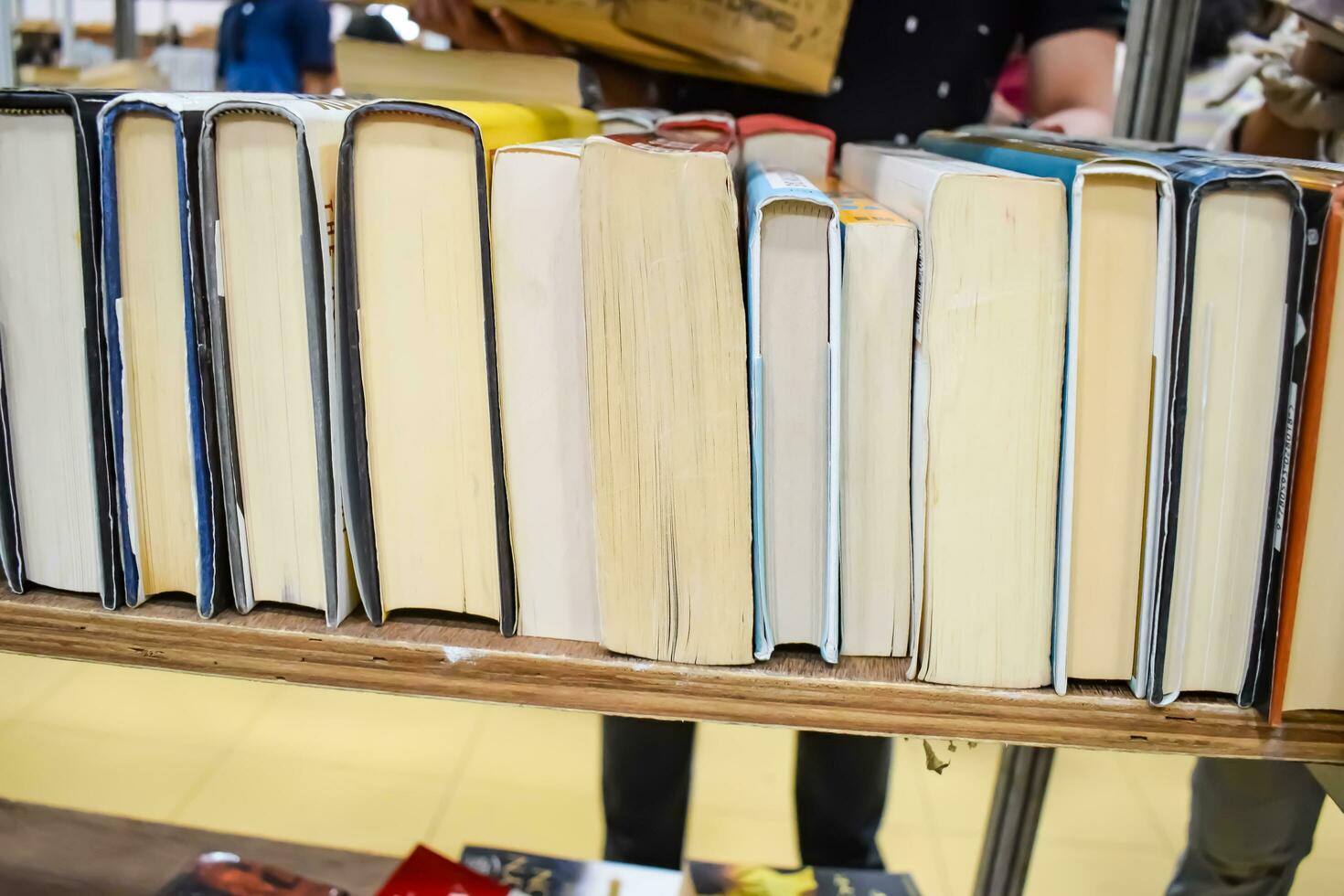 New Delhi, India, September 09 2023 - Variety of Books on shelf inside a book-stall at Delhi International Book Fair, Selection of books on display in Annual Book Fair. photo