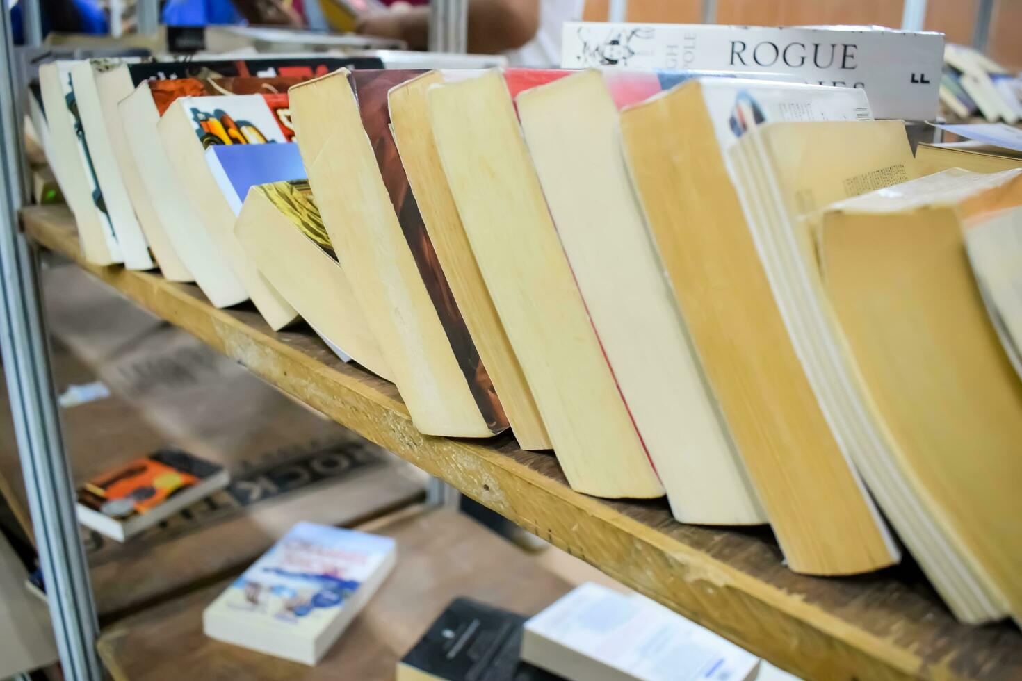 New Delhi, India, September 09 2023 - Variety of Books on shelf inside a book-stall at Delhi International Book Fair, Selection of books on display in Annual Book Fair. photo