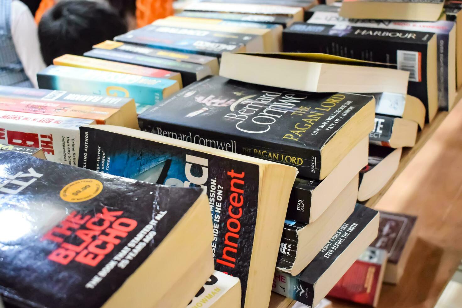 New Delhi, India, September 09 2023 - Variety of Books on shelf inside a book-stall at Delhi International Book Fair, Selection of books on display in Annual Book Fair. photo