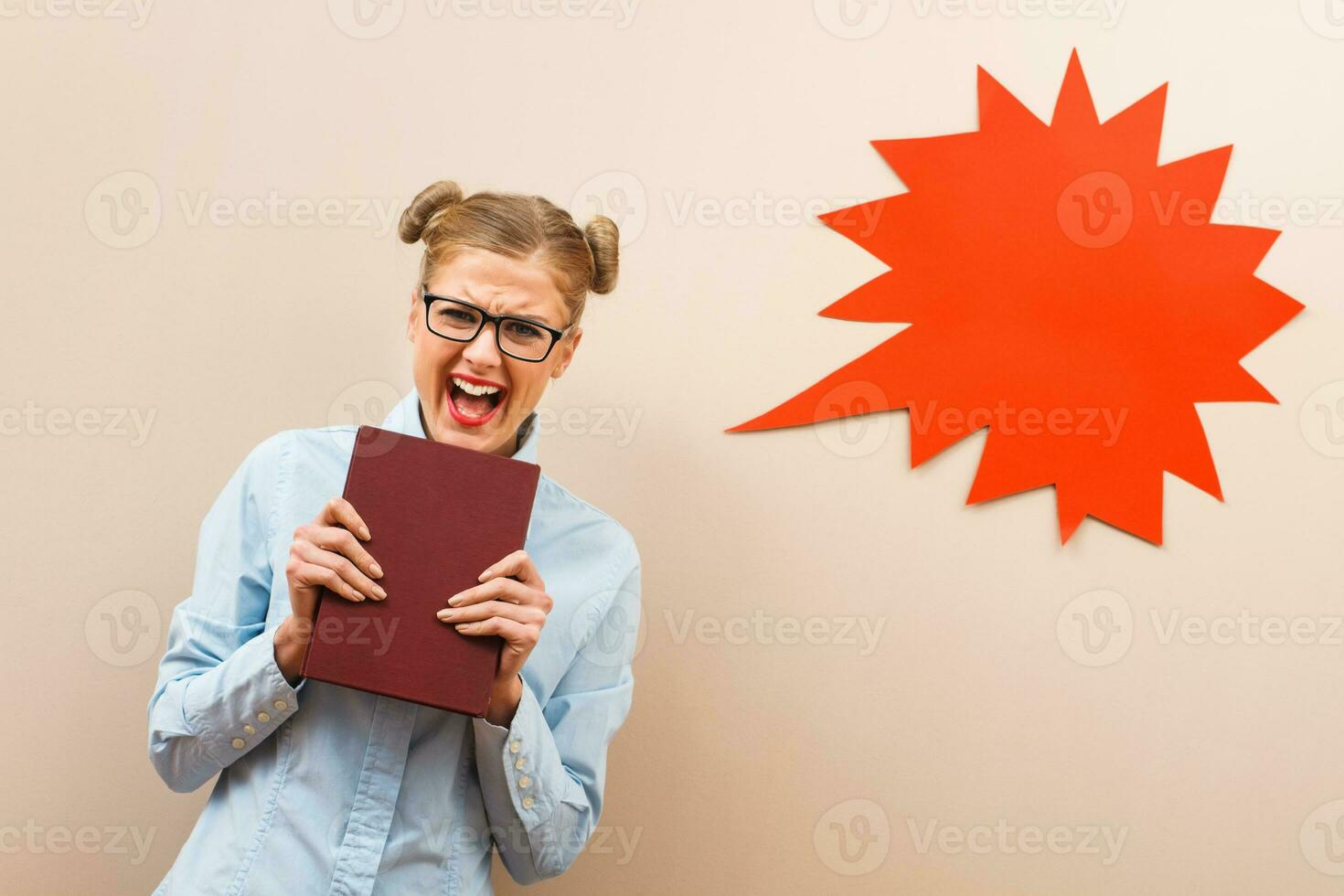 Angry geek girl with a book photo