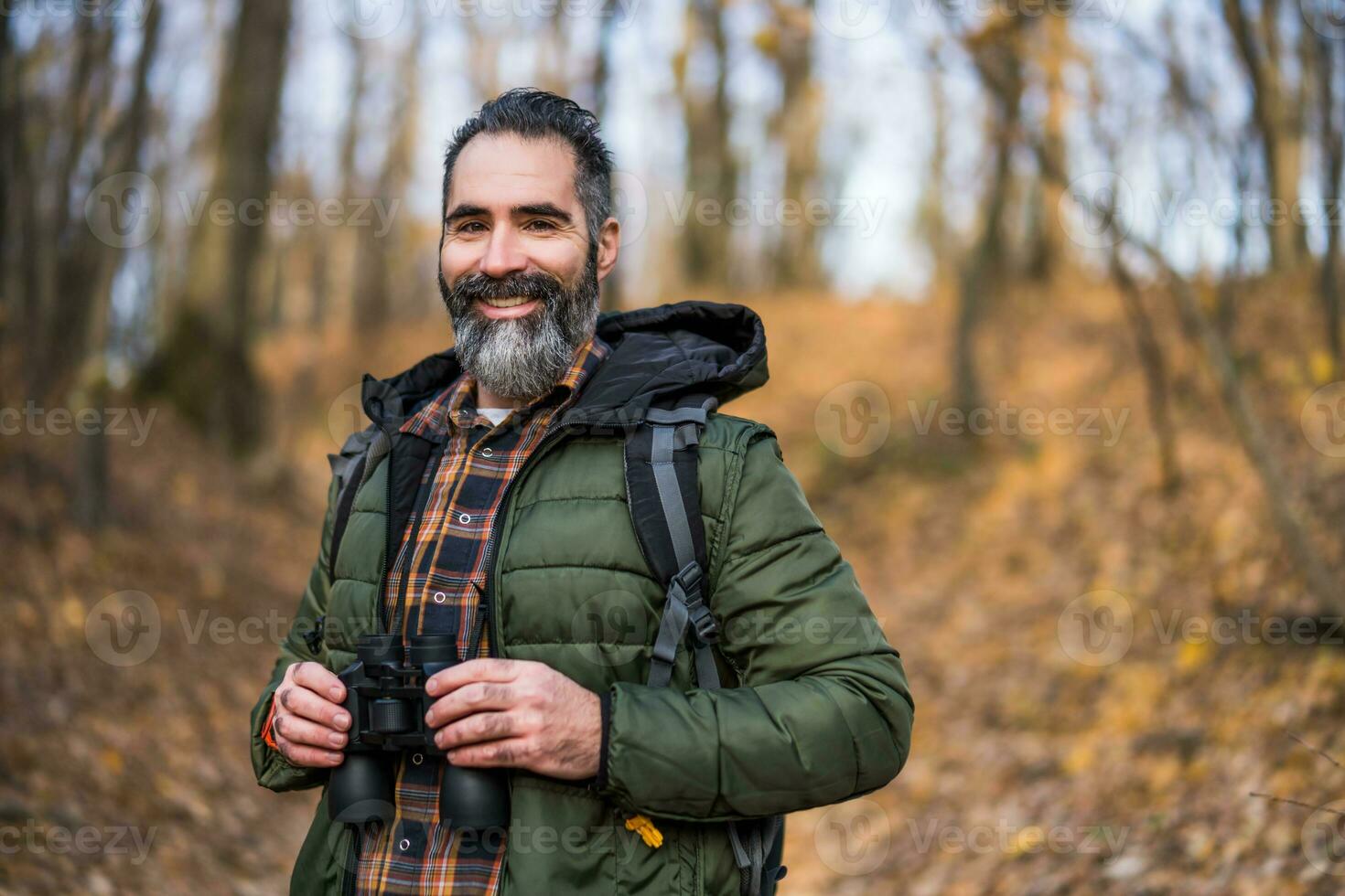 Image of man hiking and using binoculars photo