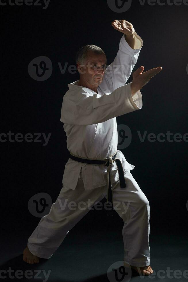 Senior man practicing karate photo