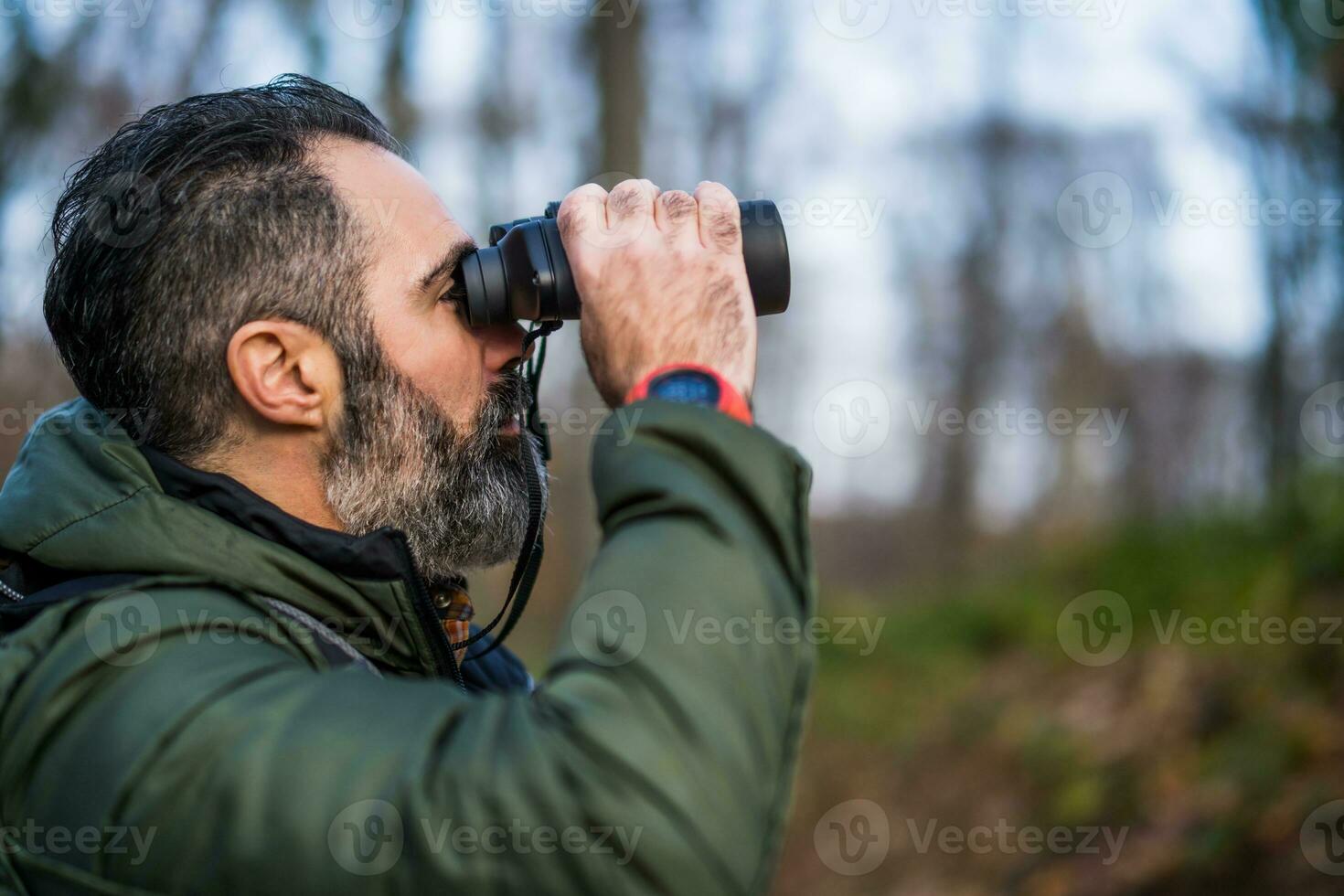 Image of man hiking and using binoculars photo