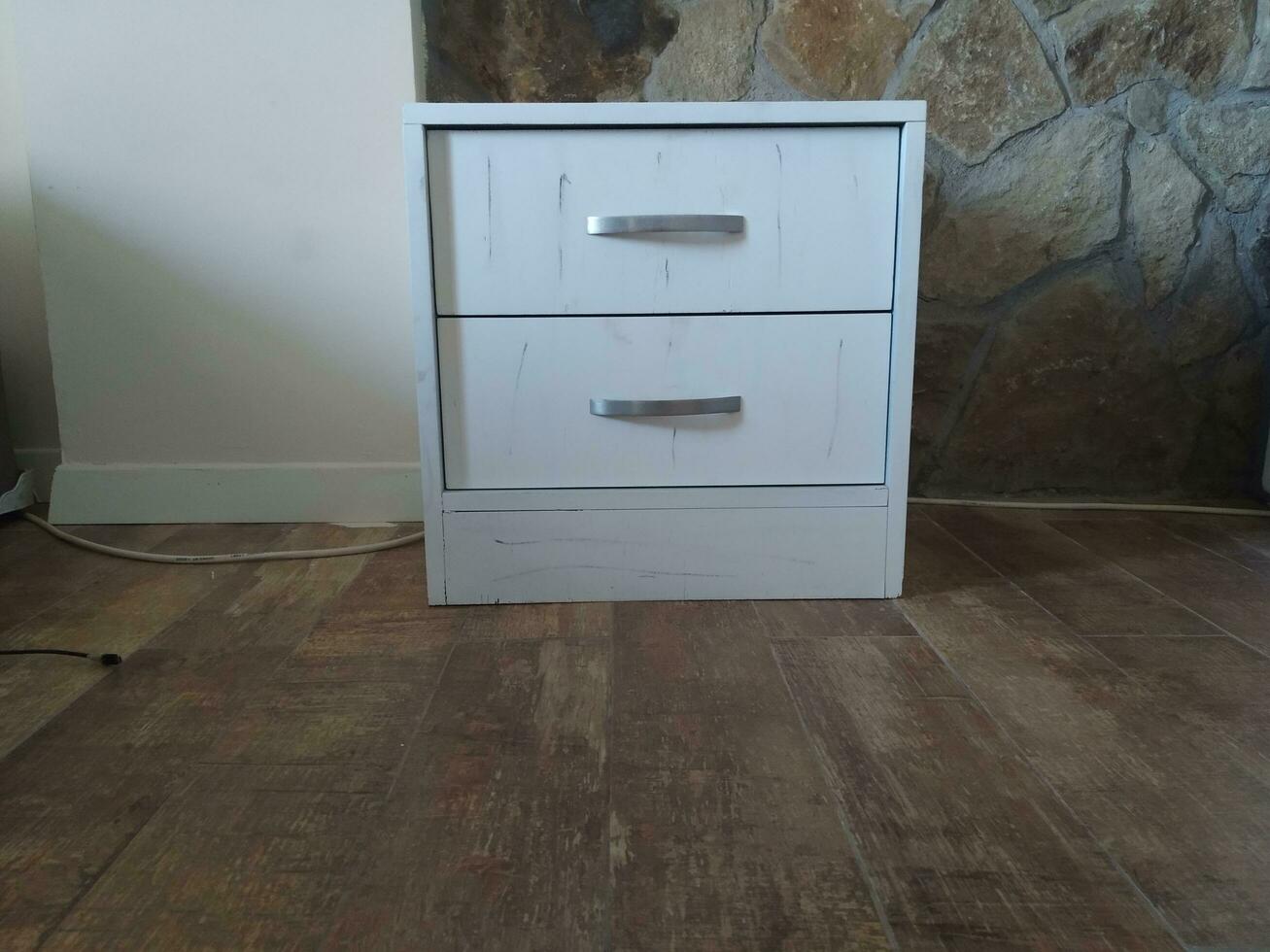 white chest of drawers on the floor in the interior of the room photo