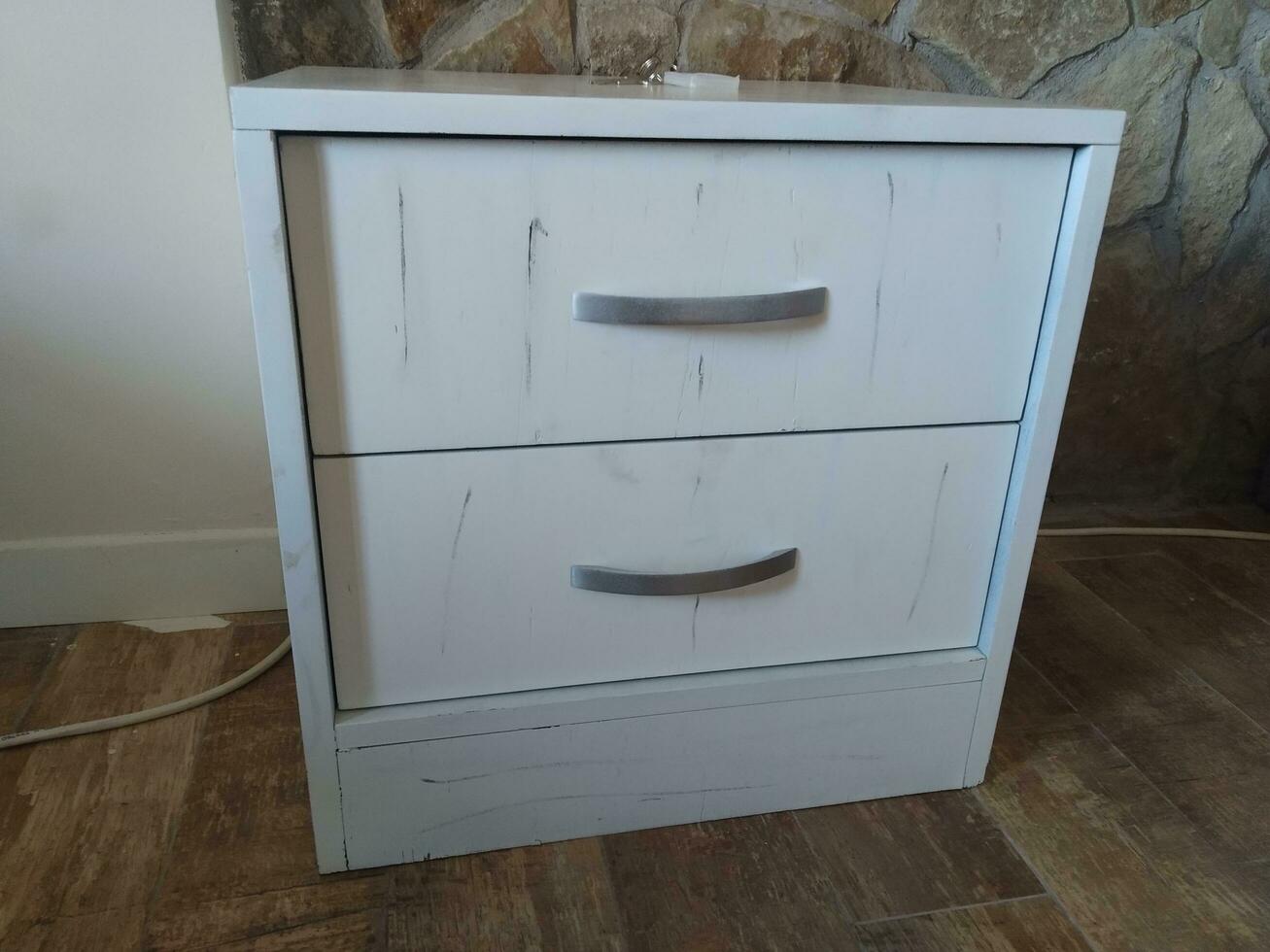 white chest of drawers on the floor in the interior of the room photo