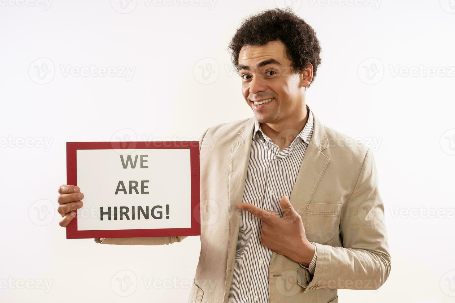 Image of businessman holding paper with text we are hiring photo