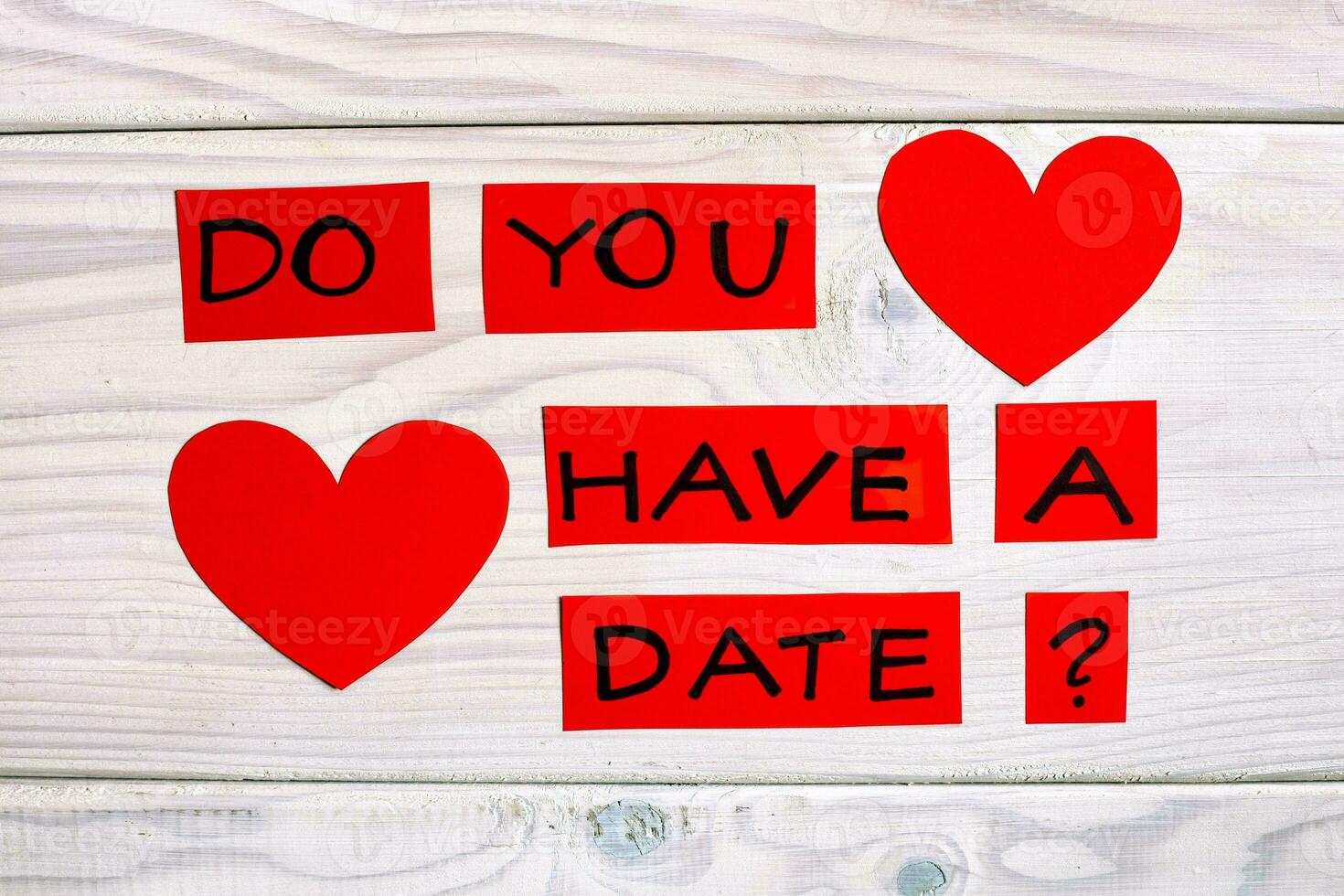 Question do you have a date and heart shapes on wooden table photo