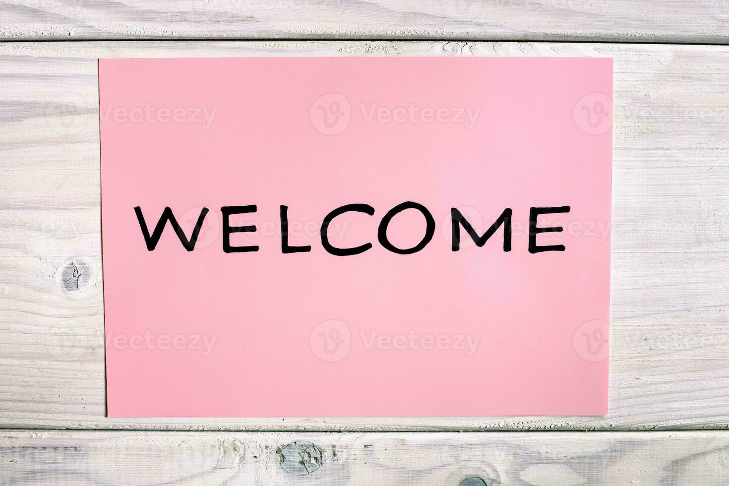 Welcome sign on wooden background photo