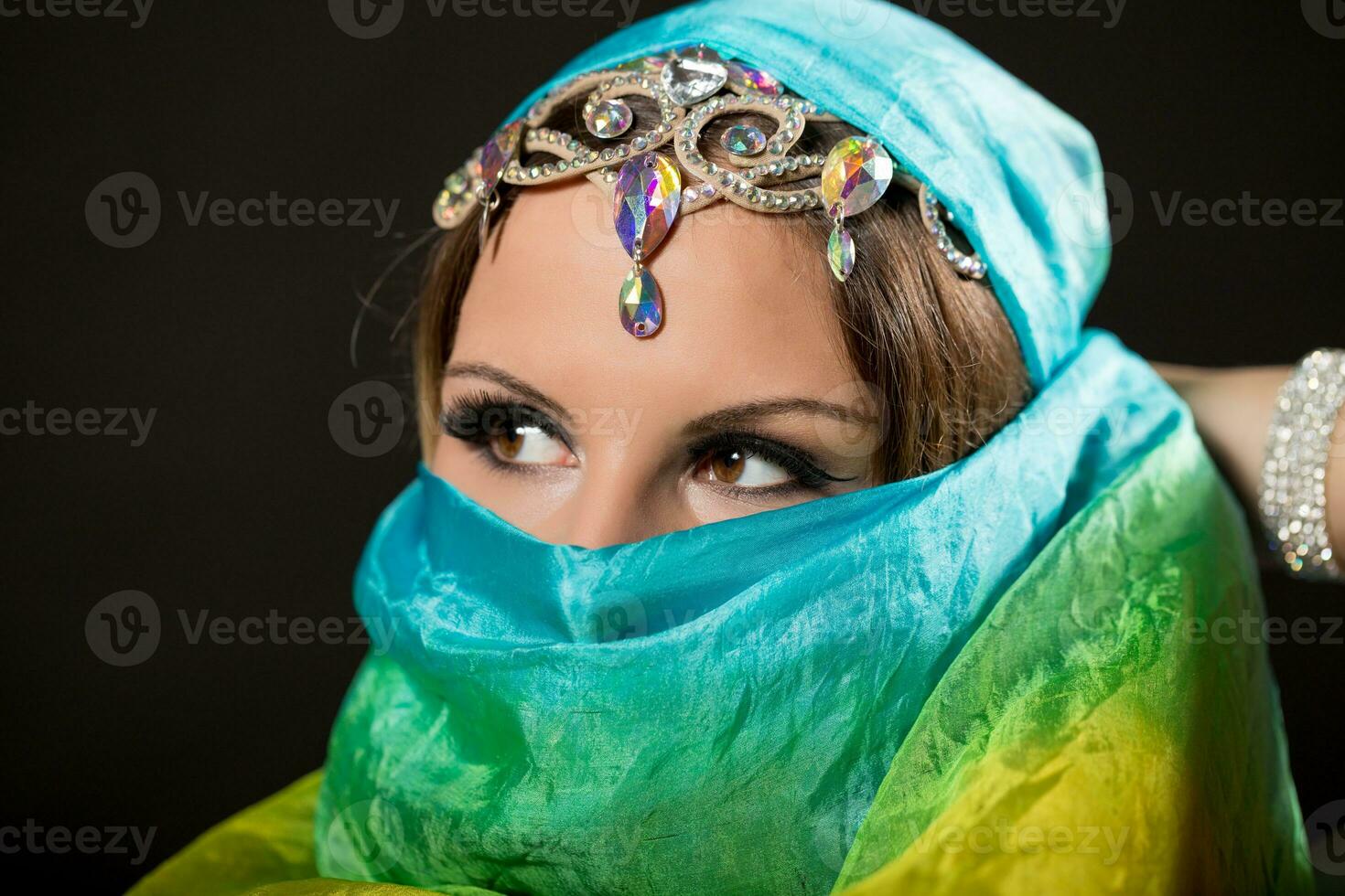 Close up portrait of belly dancer wrapped in veil photo