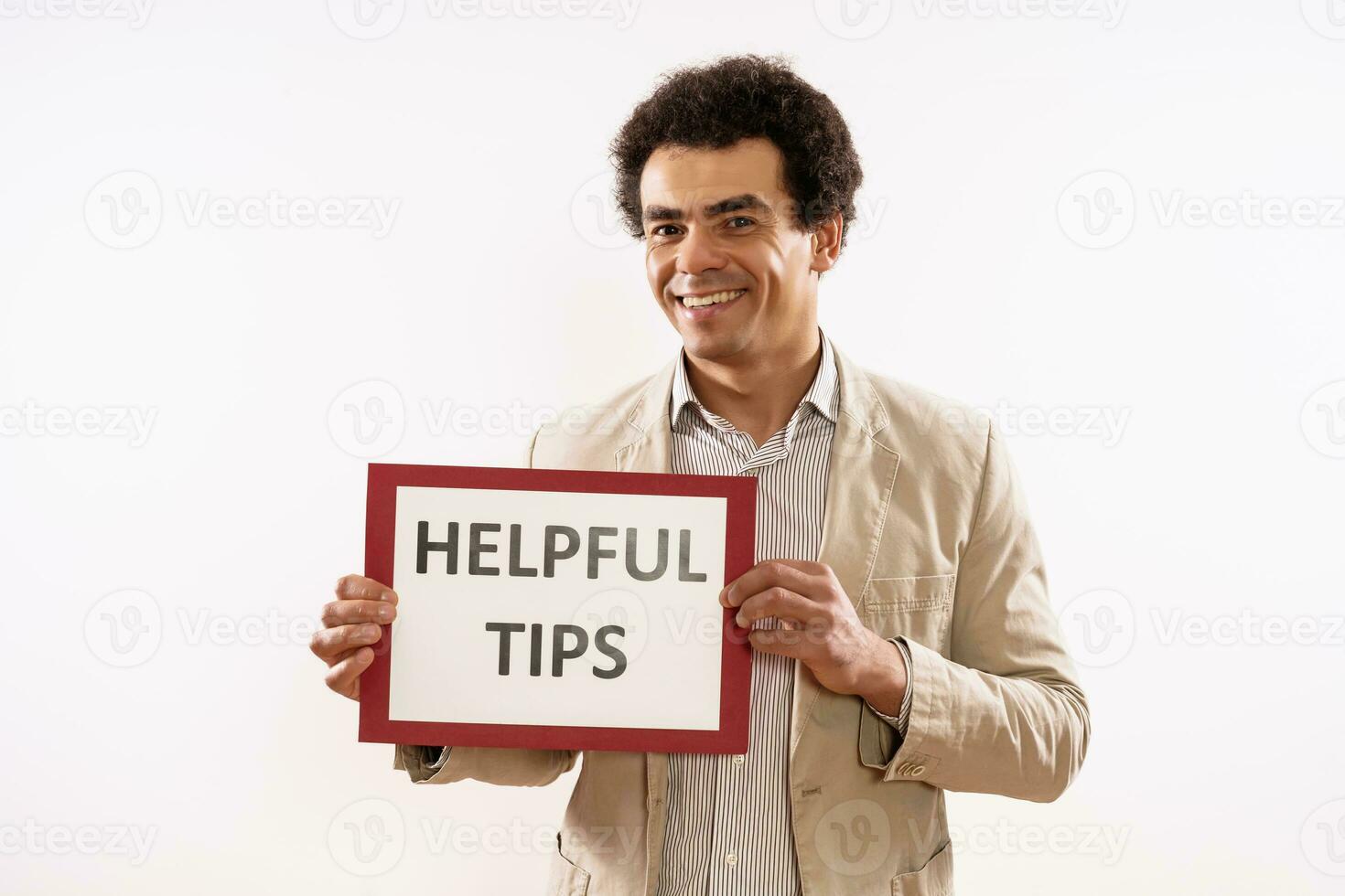 Image of businessman holding paper with text helpful tips photo