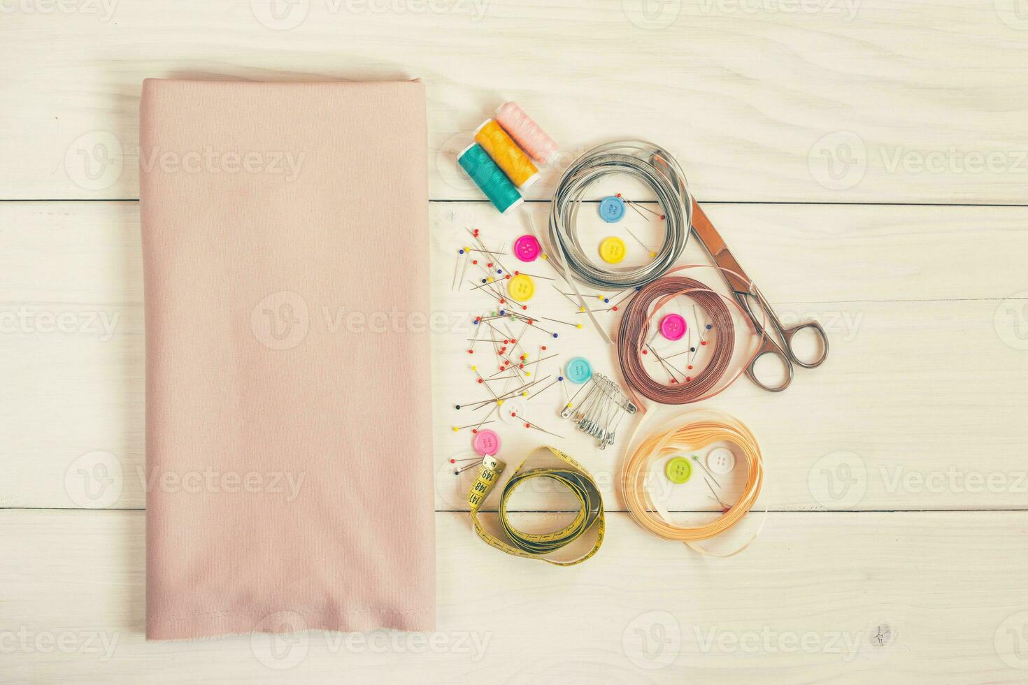 Sewing accessories on wooden table photo