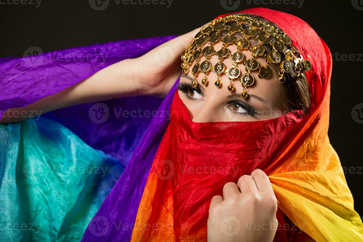 Close up portrait of belly dancer wrapped in veil photo