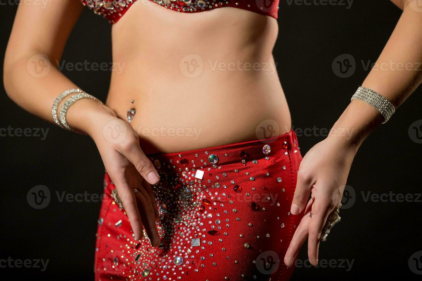 Image of belly dancer performing belly dance on black background photo