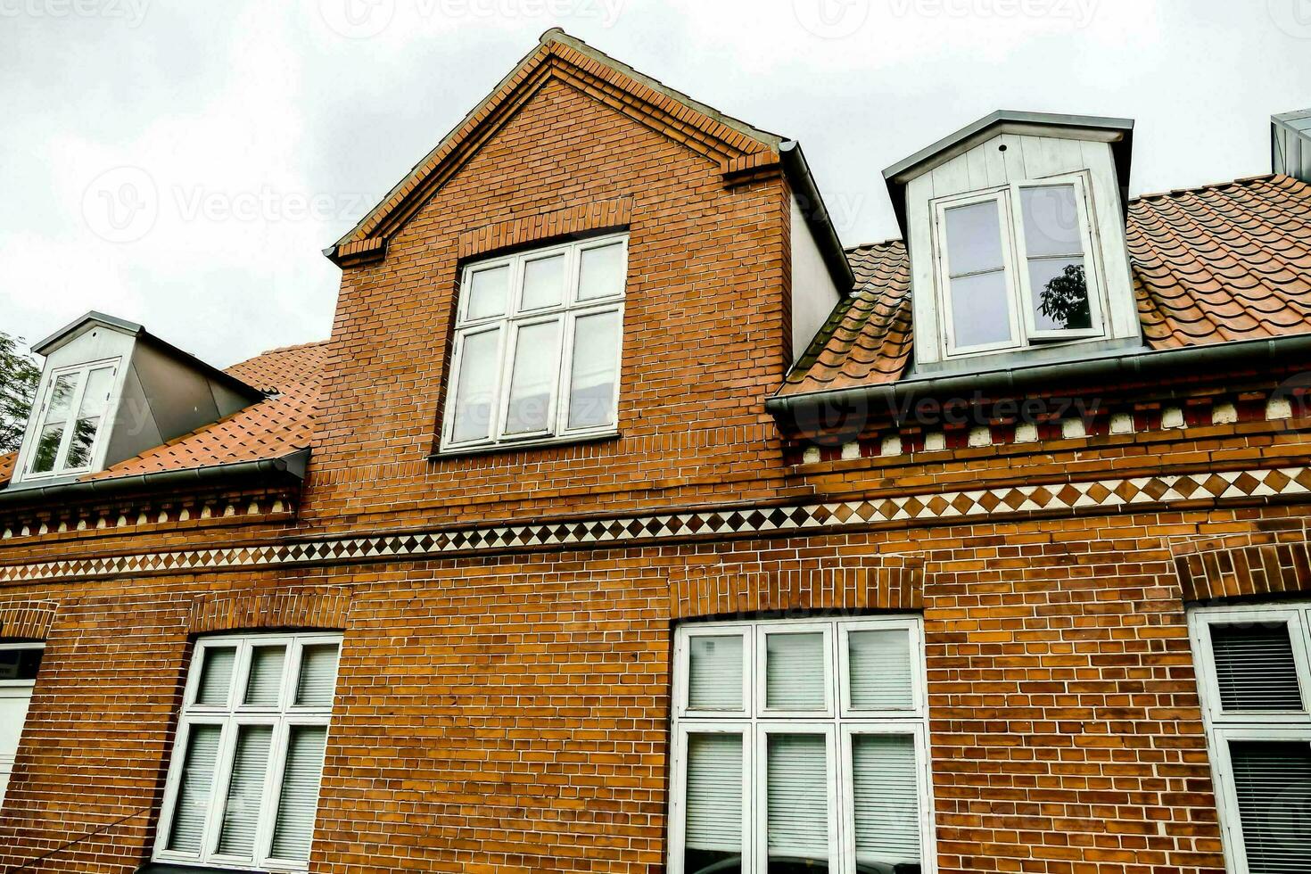 a red brick building with white windows photo