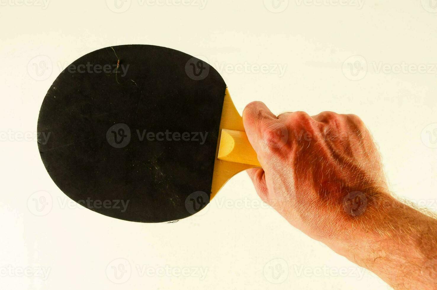 a hand holding a black paddle photo