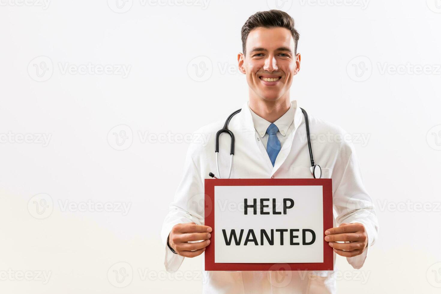 Image of doctor holding a paper with a text help wanted photo