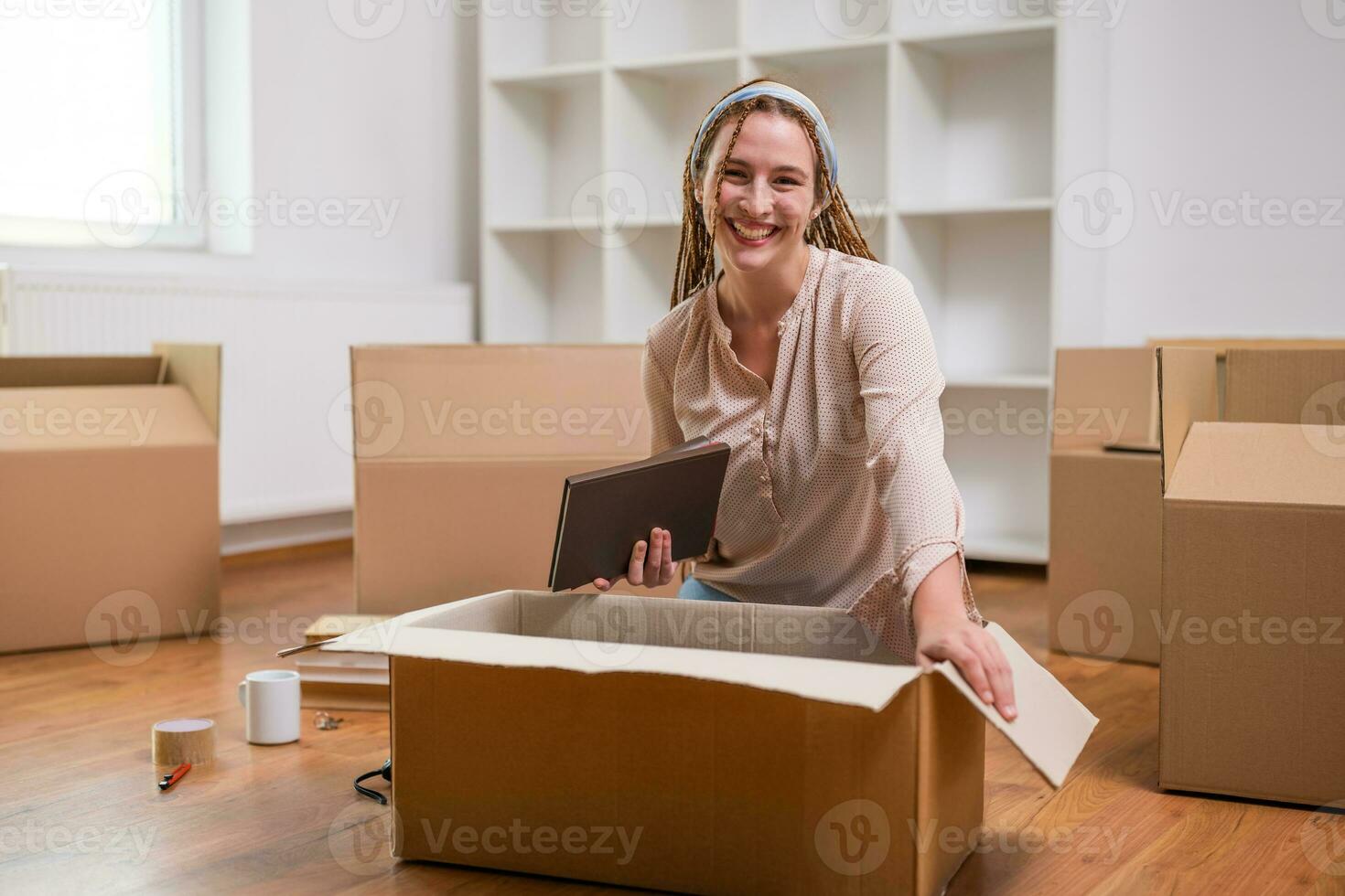 Modern ginger woman with braids moving into new home photo