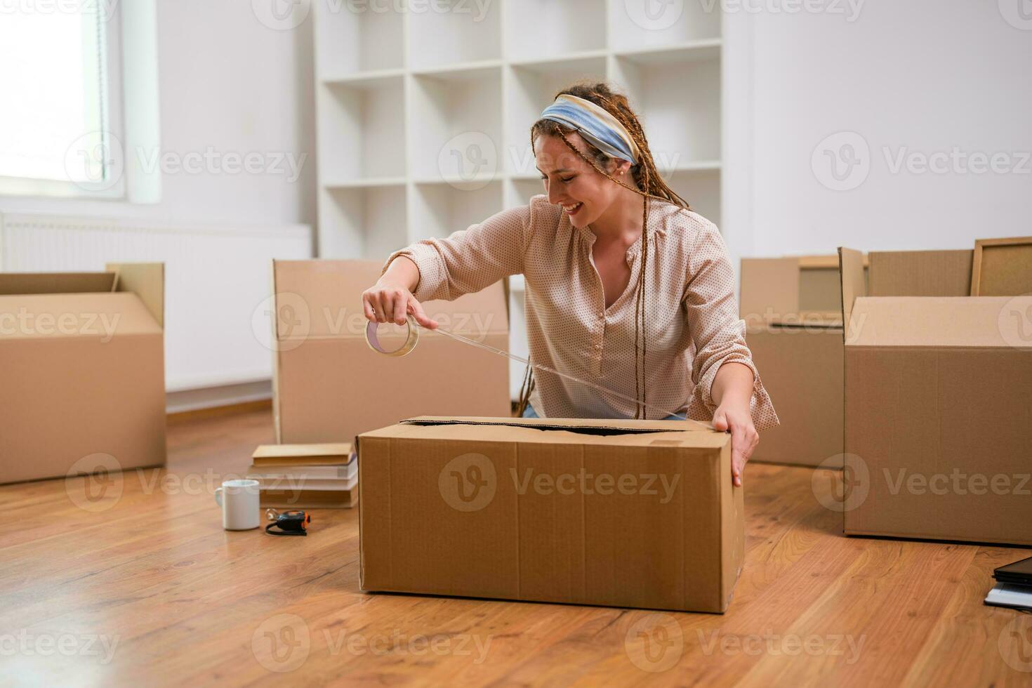 Modern ginger woman with braids moving into new home photo