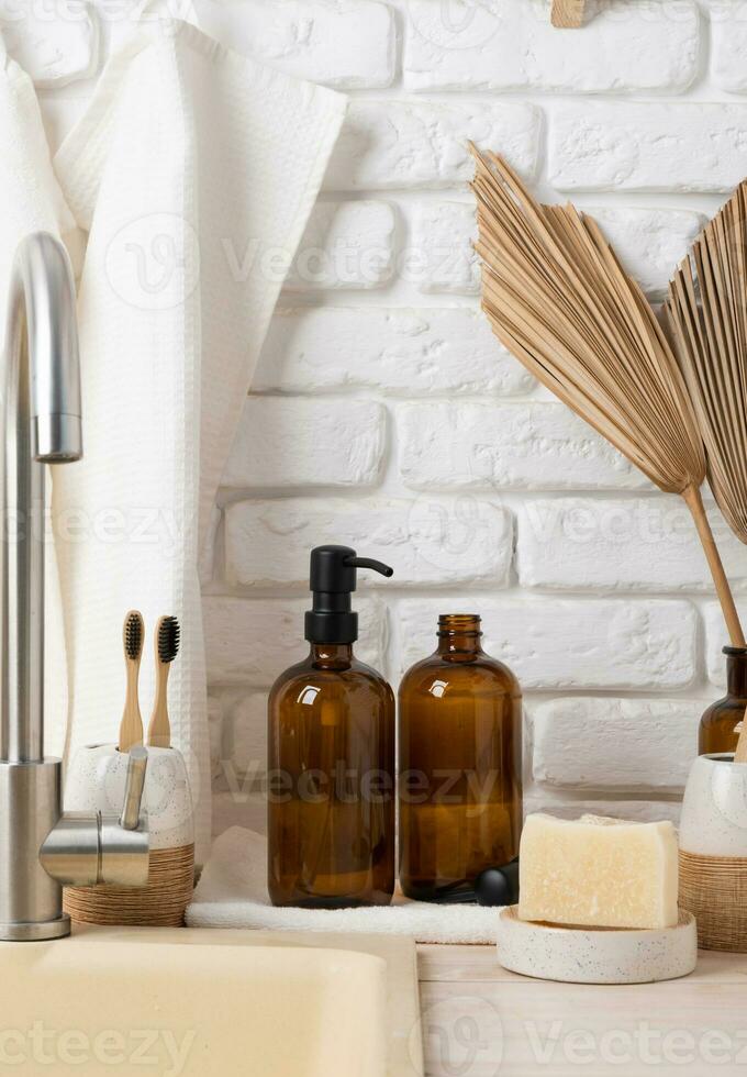 Recycled plastic pump bottle for mockup on white brick wall background near sink photo